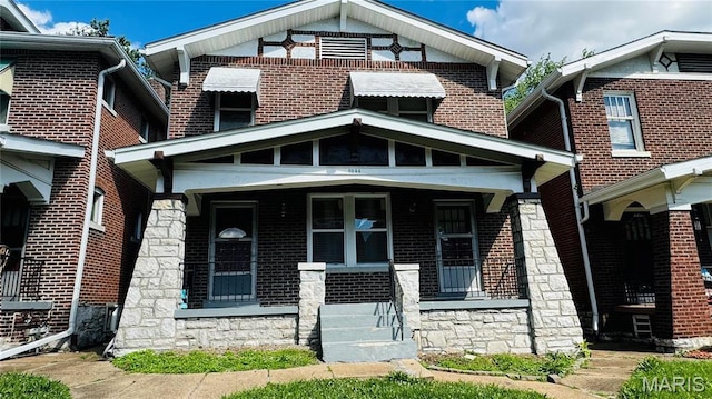 5044 Louisiana Ave, Saint Louis, MO 63111 - traditional style home featuring stone siding, covered porch, and brick siding
