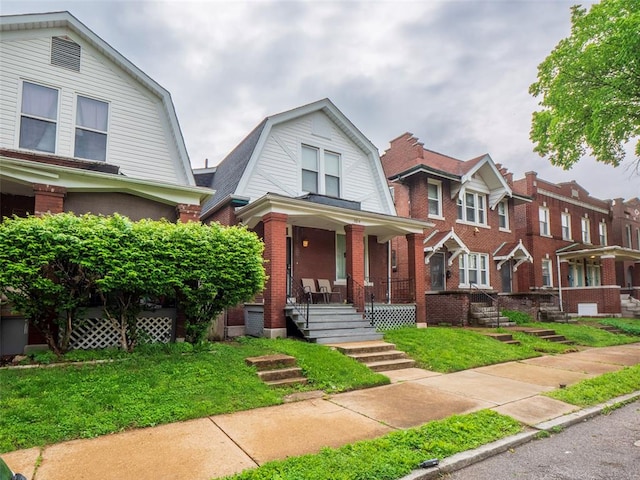 2614 Minnesota, Saint Louis, MO 63118 - colonial inspired home with a gambrel roof, a porch, brick siding, and a front lawn
