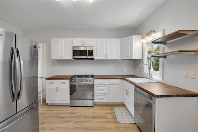 120 W Thornton Ave, Webster Groves, MO 63119 - kitchen featuring wooden counters, stainless steel appliances, a sink, and white cabinets