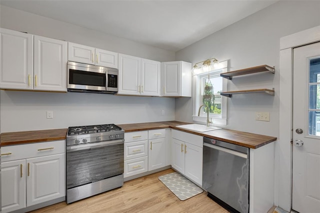 120 W Thornton Ave, Webster Groves, MO 63119 - kitchen featuring wooden counters, appliances with stainless steel finishes, a sink, and healthy amount of natural light