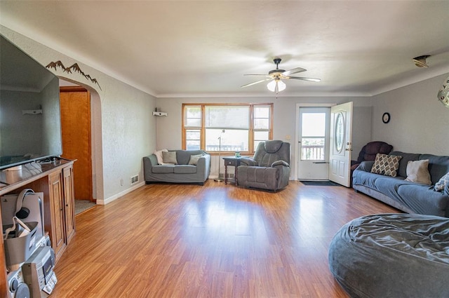300 N Alvarado Ave, Belle, MO 65013 - living room featuring ceiling fan, arched walkways, wood finished floors, and baseboards