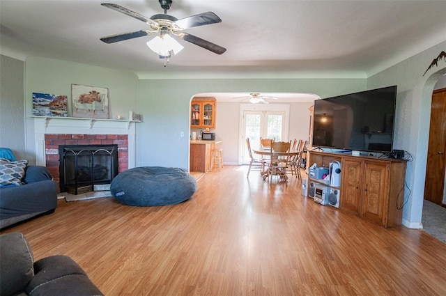 300 N Alvarado Ave, Belle, MO 65013 - living area featuring arched walkways, ceiling fan, wood finished floors, and a brick fireplace