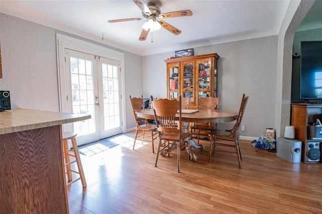 300 N Alvarado Ave, Belle, MO 65013 - dining room with a textured wall, light wood-style floors, a ceiling fan, french doors, and baseboards