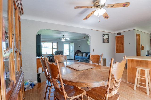 300 N Alvarado Ave, Belle, MO 65013 - dining space featuring arched walkways, a ceiling fan, and light wood finished floors