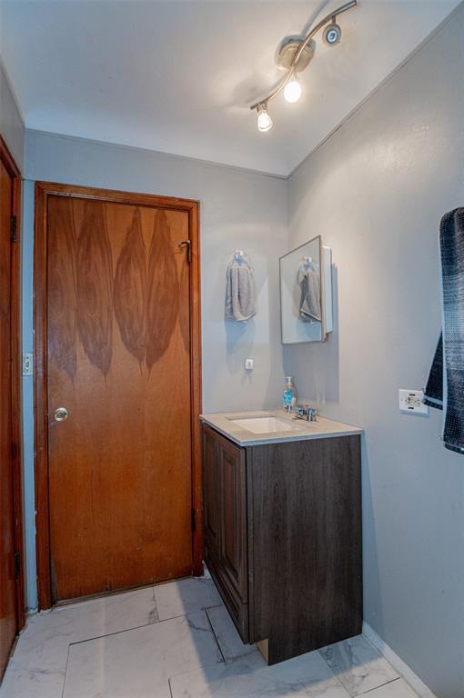 300 N Alvarado Ave, Belle, MO 65013 - bathroom with marble look tile flooring and vanity