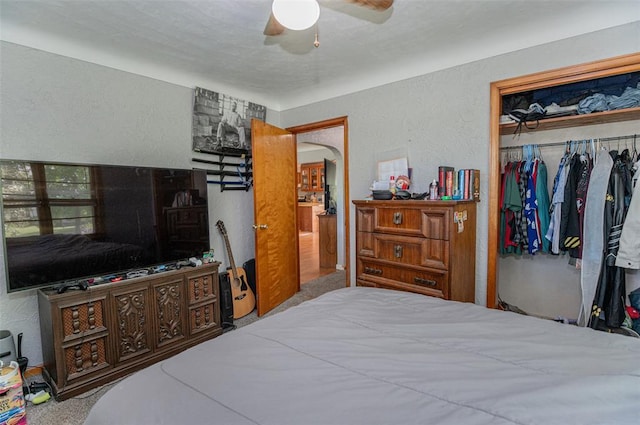 300 N Alvarado Ave, Belle, MO 65013 - bedroom with a textured wall, a closet, a ceiling fan, and arched walkways