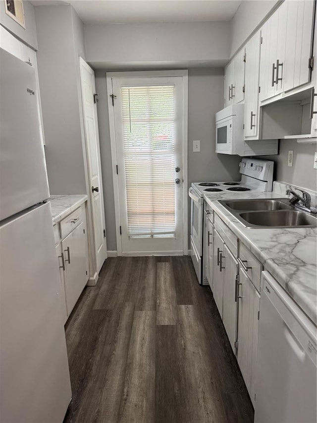 635 Rosetta Dr Unit D, Florissant, MO 63031 - kitchen featuring white appliances, dark wood finished floors, a sink, light countertops, and white cabinets