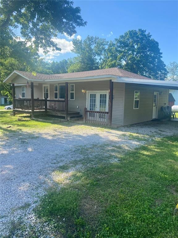 102 Willow St, Van Buren, MO 63965 - view of front of house with a front lawn, an attached carport, driveway, and french doors