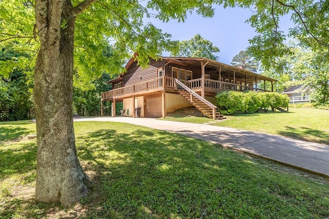 765 Carter 103, Van Buren, MO 63965 - view of front facade featuring concrete driveway, a front yard, a deck, and stairs