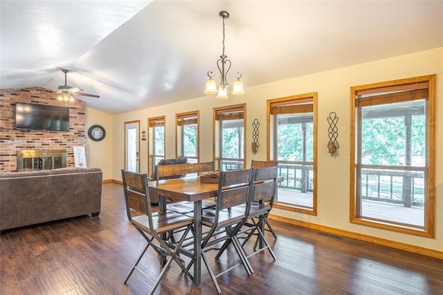 765 Carter 103, Van Buren, MO 63965 - dining space with vaulted ceiling, baseboards, dark wood-style flooring, ceiling fan, and a fireplace
