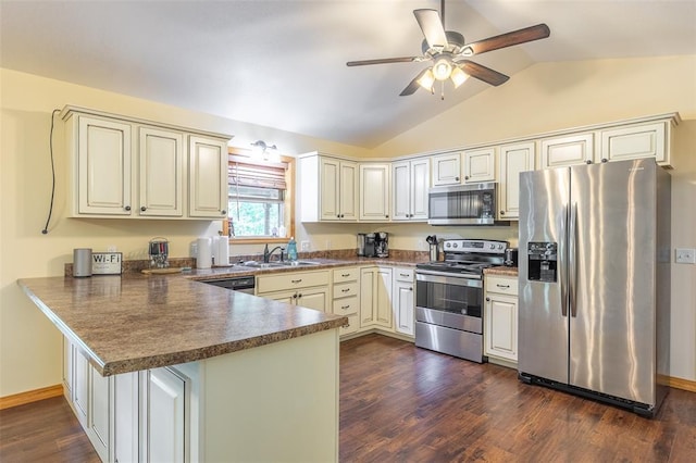 765 Carter 103, Van Buren, MO 63965 - kitchen with stainless steel appliances, a peninsula, vaulted ceiling, dark countertops, and dark wood-style flooring