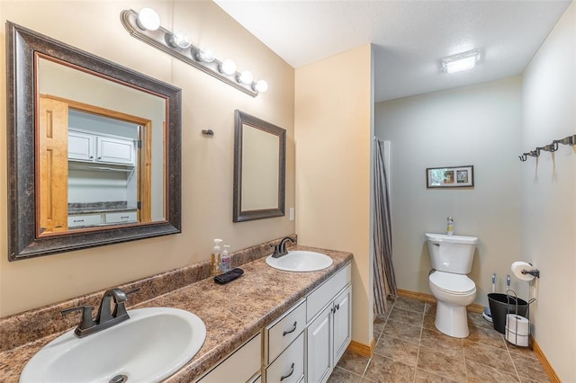 765 Carter 103, Van Buren, MO 63965 - bathroom featuring double vanity, toilet, baseboards, and a shower with shower curtain