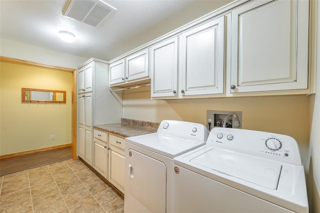 765 Carter 103, Van Buren, MO 63965 - washroom featuring cabinet space, washing machine and clothes dryer, and baseboards
