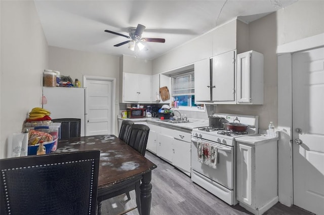 8033 Winfield Ave, Saint Louis, MO 63114 - kitchen with white appliances, a sink, white cabinets, light countertops, and ceiling fan