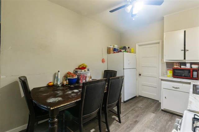 8033 Winfield Ave, Saint Louis, MO 63114 - dining room with a ceiling fan, light wood finished floors, and vaulted ceiling