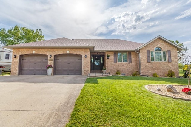 2115 Tower Rd, Lebanon, MO 65536 - single story home with a garage, brick siding, driveway, a front lawn, and a shingled roof