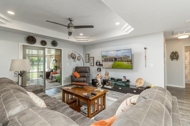 2115 Tower Rd, Lebanon, MO 65536 - living room featuring wood finished floors, baseboards, ceiling fan, recessed lighting, and a tray ceiling