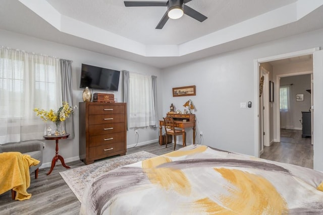 2115 Tower Rd, Lebanon, MO 65536 - bedroom featuring wood finished floors, a raised ceiling, baseboards, and ceiling fan