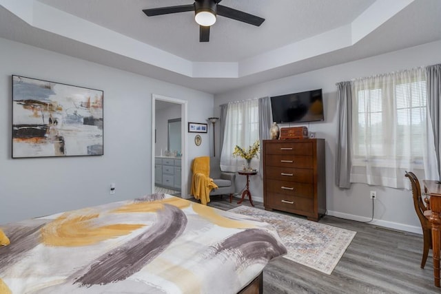2115 Tower Rd, Lebanon, MO 65536 - bedroom with multiple windows, a tray ceiling, wood finished floors, and baseboards