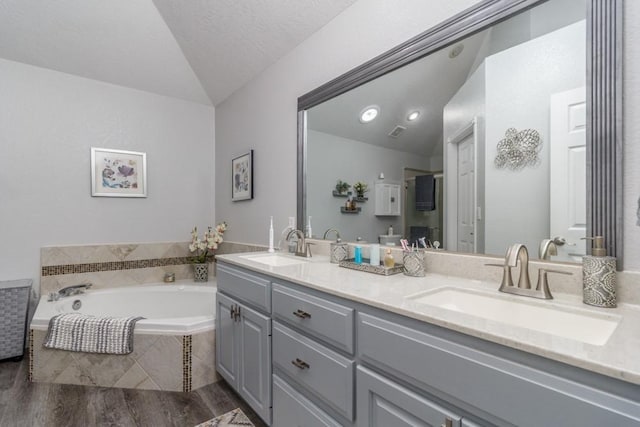 2115 Tower Rd, Lebanon, MO 65536 - full bath with vaulted ceiling, double vanity, a bath, and wood finished floors