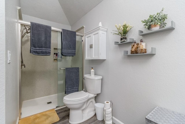 2115 Tower Rd, Lebanon, MO 65536 - bathroom with wood finished floors, toilet, a shower stall, lofted ceiling, and baseboards
