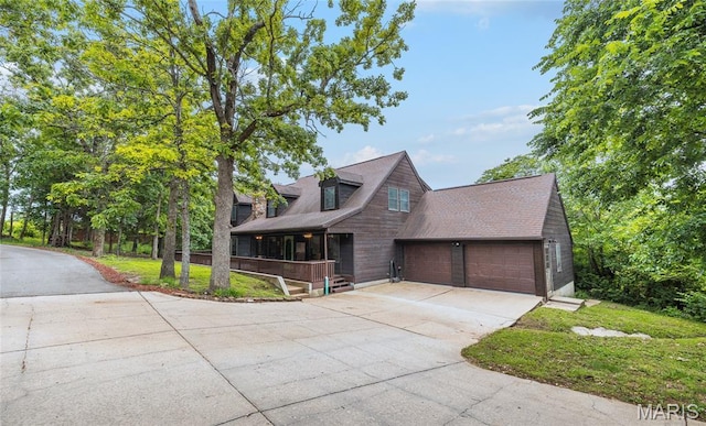 13399 S US Highway 63, Rolla, MO 65401 - view of front facade with concrete driveway, an attached garage, covered porch, and a shingled roof