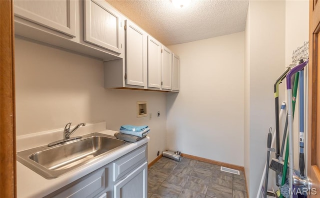 13399 S US Highway 63, Rolla, MO 65401 - laundry room featuring cabinet space, hookup for a washing machine, hookup for an electric dryer, a textured ceiling, and baseboards