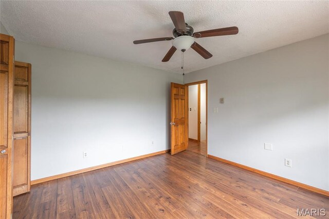 13399 S US Highway 63, Rolla, MO 65401 - unfurnished room with baseboards, wood finished floors, ceiling fan, and a textured ceiling