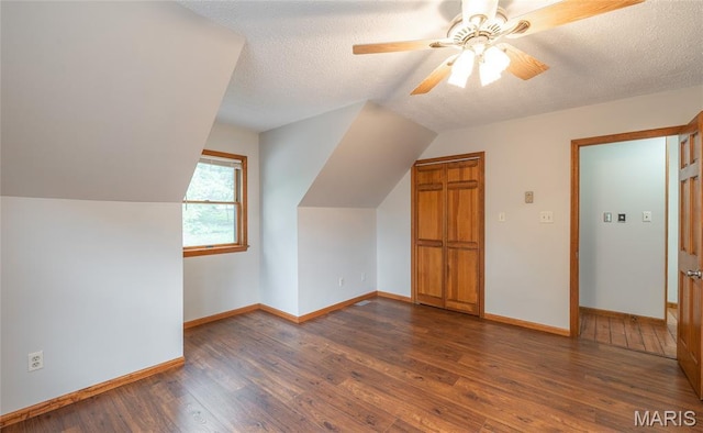 13399 S US Highway 63, Rolla, MO 65401 - additional living space with wood finished floors, vaulted ceiling, baseboards, ceiling fan, and a textured ceiling