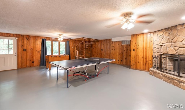 13399 S US Highway 63, Rolla, MO 65401 - rec room with a ceiling fan, a textured ceiling, plenty of natural light, wood walls, and concrete floors