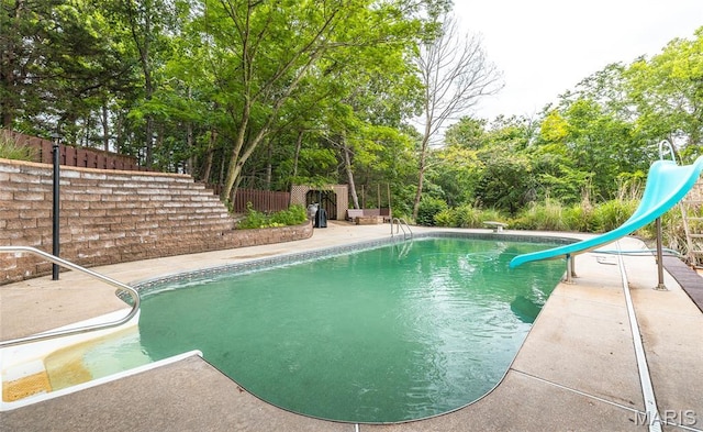 13399 S US Highway 63, Rolla, MO 65401 - view of swimming pool with a water slide, view of wooded area, and a patio area