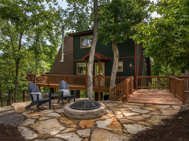 2717 Frieden Pass Dr, Innsbrook, MO 63390 - rear view of property featuring an outdoor fire pit, a deck, and a patio area