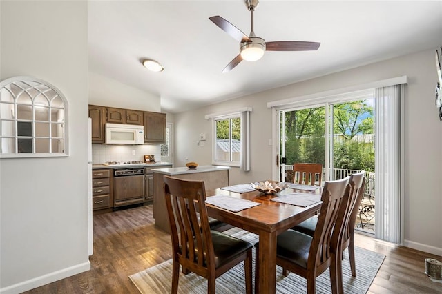 1090 Apache Dr, Florissant, MO 63033 - dining room with a ceiling fan, dark wood-type flooring, lofted ceiling, and baseboards