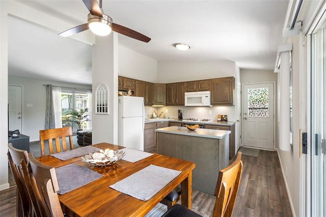 1090 Apache Dr, Florissant, MO 63033 - dining space featuring dark wood-style floors, ceiling fan, vaulted ceiling, and baseboards