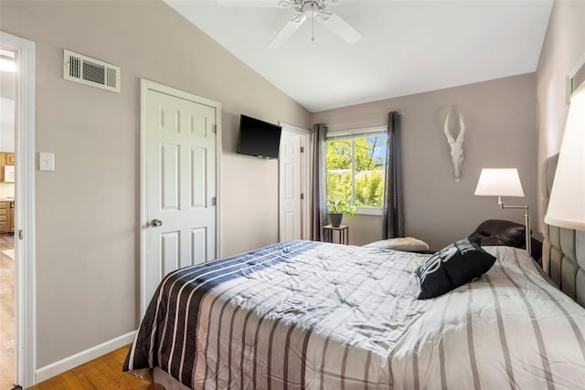 1090 Apache Dr, Florissant, MO 63033 - bedroom featuring wood finished floors, lofted ceiling, baseboards, and a ceiling fan