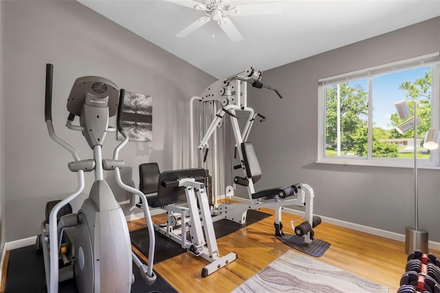 1090 Apache Dr, Florissant, MO 63033 - workout area featuring a ceiling fan, wood finished floors, baseboards, and vaulted ceiling