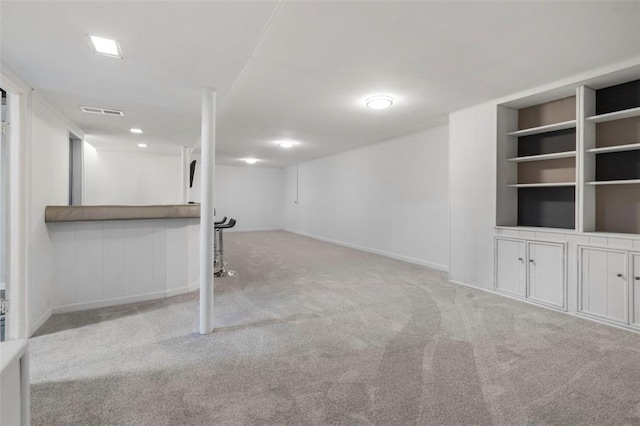 1090 Apache Dr, Florissant, MO 63033 - finished below grade area with carpet floors, baseboards, and built in features