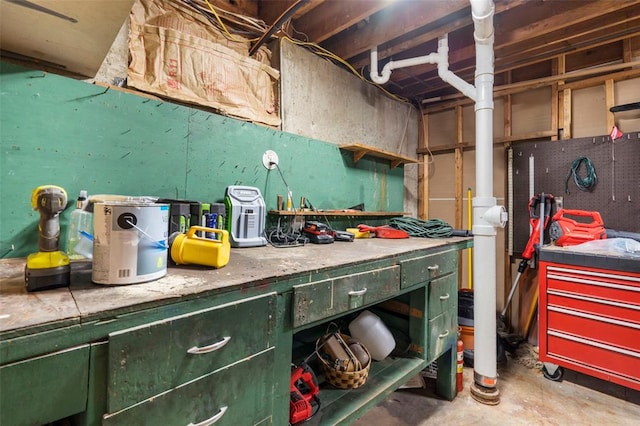 1090 Apache Dr, Florissant, MO 63033 - miscellaneous room featuring a workshop area and unfinished concrete floors