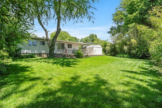 1090 Apache Dr, Florissant, MO 63033 - view of green lawn featuring a wooden deck