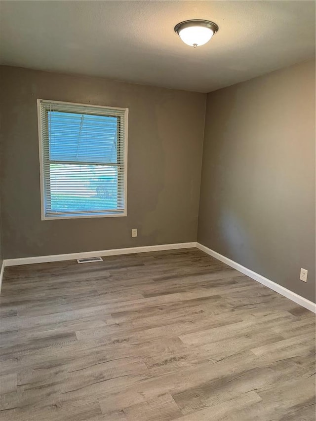 1341 Criterion Ave, Saint Louis, MO 63138 - spare room featuring wood finished floors and baseboards