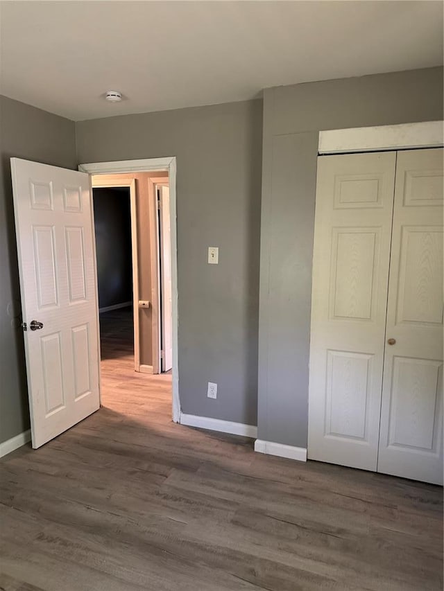 1341 Criterion Ave, Saint Louis, MO 63138 - unfurnished bedroom with wood finished floors, a closet, and baseboards