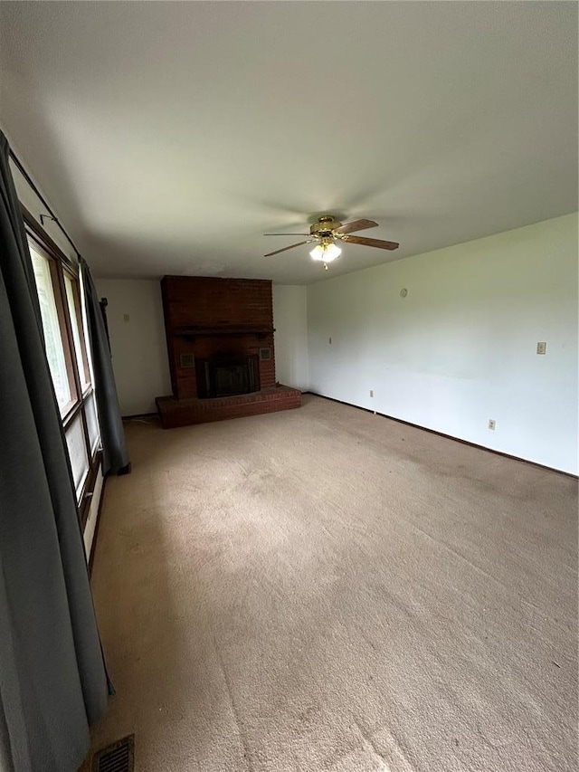21008 W State Highway 47, Lonedell, MO 63060 - unfurnished living room with ceiling fan, a brick fireplace, and light carpet