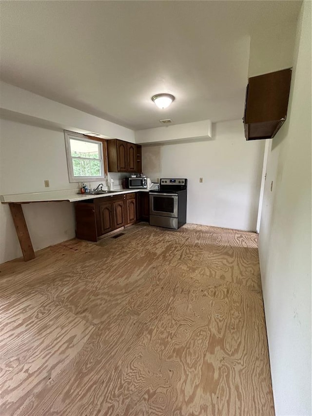 21008 W State Highway 47, Lonedell, MO 63060 - kitchen with appliances with stainless steel finishes, dark brown cabinetry, light countertops, and a sink