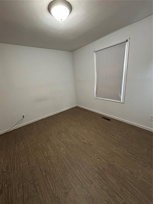 21008 W State Highway 47, Lonedell, MO 63060 - spare room featuring dark wood-style floors and baseboards