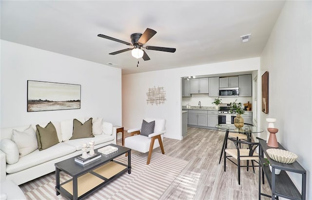 2613 Hillsboro Valley Park Rd, High Ridge, MO 63049 - living area with ceiling fan, light wood-style floors, and baseboards