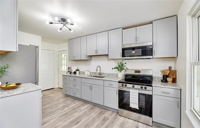 2613 Hillsboro Valley Park Rd, High Ridge, MO 63049 - kitchen with stainless steel appliances, a sink, gray cabinets, and light wood-style flooring