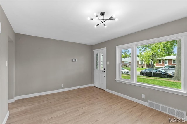 8364 Fullerton Ave, University City, MO 63132 - entrance foyer with a chandelier and light wood-style floors