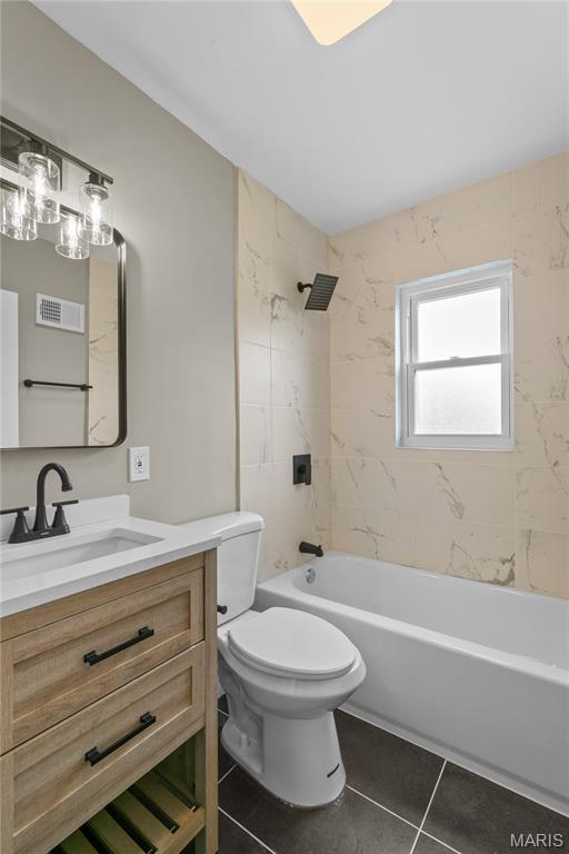 8364 Fullerton Ave, University City, MO 63132 - full bathroom featuring vanity, tile patterned floors, and tub / shower combination
