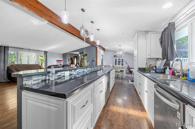 2850 S Hwy W, Winfield, MO 63389 - kitchen with stainless steel dishwasher, dark wood finished floors, white cabinets, hanging light fixtures, and a large island