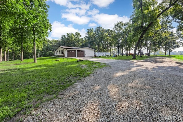 2850 S Hwy W, Winfield, MO 63389 - view of front of house featuring gravel driveway, a front yard, and an attached garage